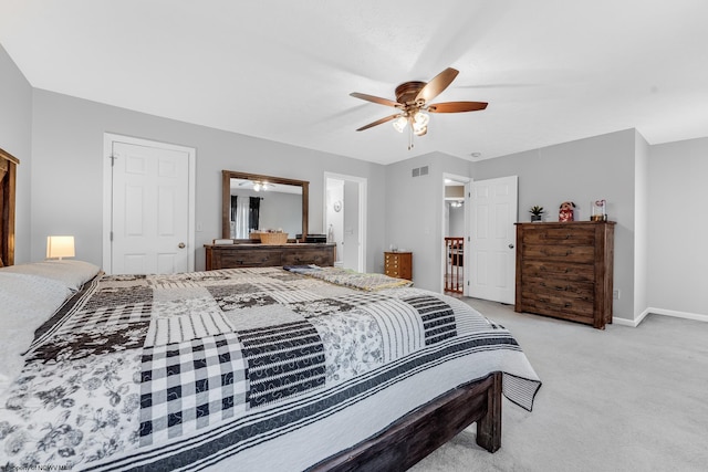 bedroom with a ceiling fan, light colored carpet, visible vents, and baseboards