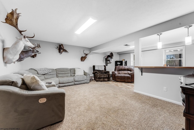 carpeted living room with baseboards