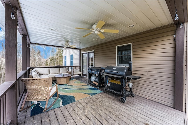 deck featuring an outdoor hangout area, grilling area, and a ceiling fan