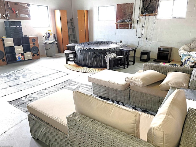 interior space featuring concrete block wall and concrete flooring