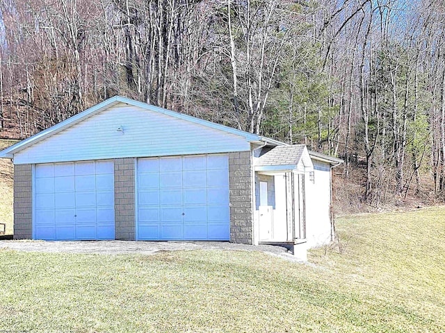 detached garage featuring a forest view