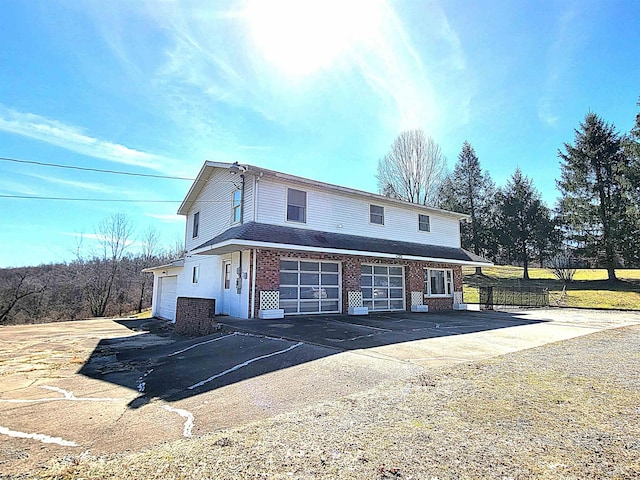 view of front of house with brick siding and driveway