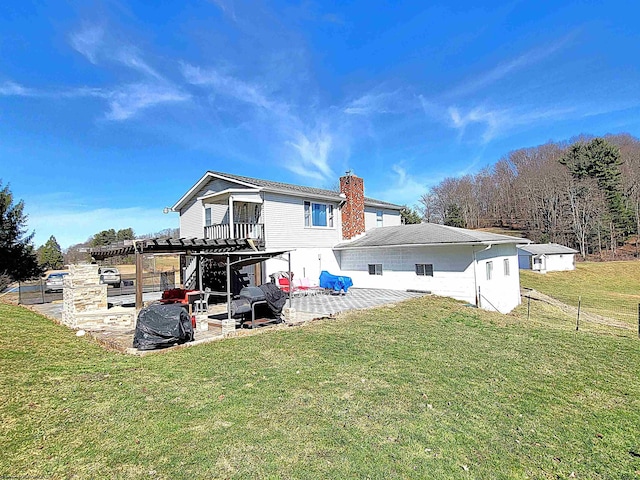 rear view of property with a patio area, a chimney, and a yard