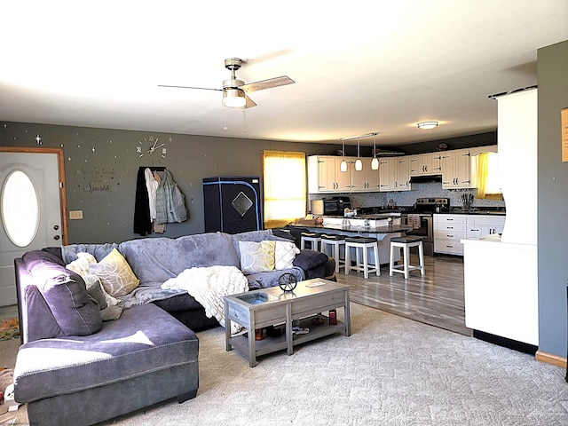 living room featuring ceiling fan and wood finished floors