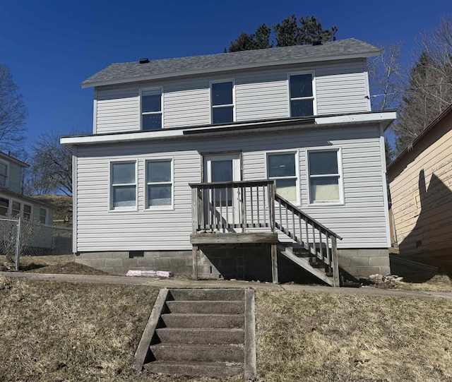 view of front facade featuring a shingled roof and crawl space