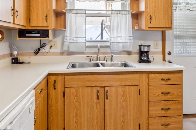 kitchen featuring dishwasher, open shelves, a sink, and light countertops