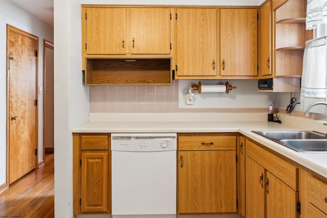 kitchen featuring a sink, light countertops, decorative backsplash, dishwasher, and open shelves