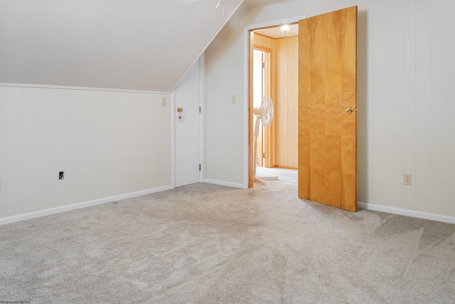 additional living space featuring baseboards, vaulted ceiling, and carpet flooring