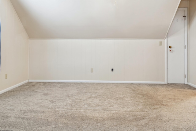 additional living space featuring carpet flooring and vaulted ceiling