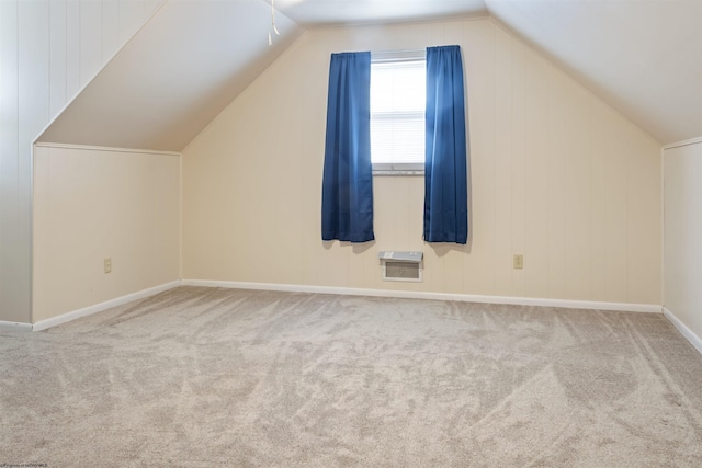 bonus room with carpet, vaulted ceiling, and heating unit