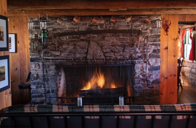 room details featuring a fireplace and wood walls