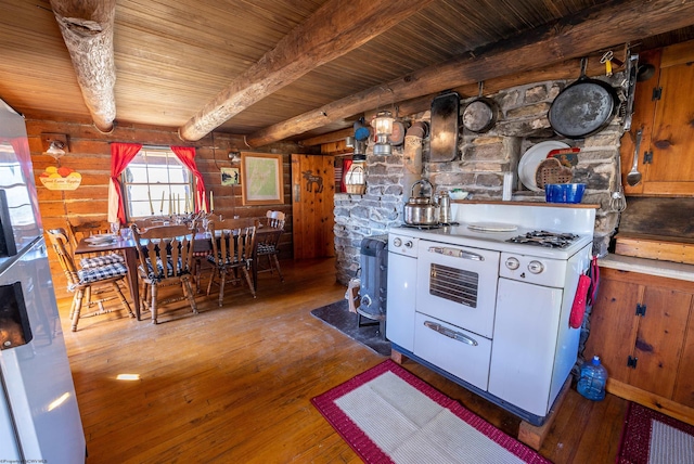 kitchen featuring rustic walls, range with two ovens, hardwood / wood-style flooring, wood ceiling, and beam ceiling