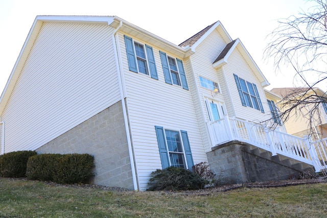 view of side of property with stairway