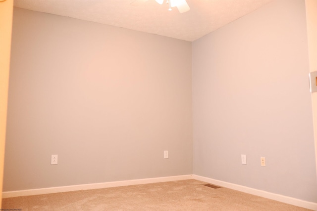 unfurnished room with ceiling fan, baseboards, and light colored carpet