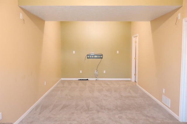 interior space featuring light carpet, baseboards, and visible vents