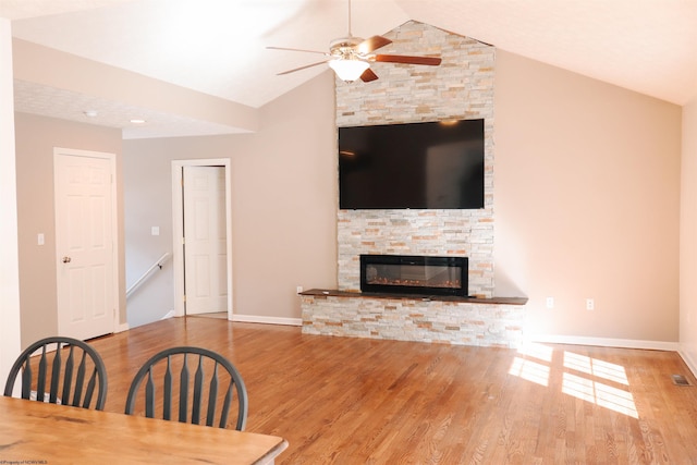 unfurnished living room featuring vaulted ceiling, ceiling fan, wood finished floors, and baseboards