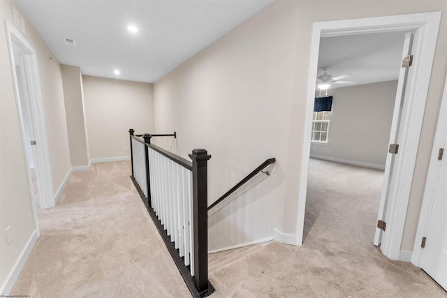 hallway featuring carpet floors, recessed lighting, an upstairs landing, and baseboards