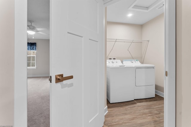 laundry room with laundry area, separate washer and dryer, wood finished floors, baseboards, and attic access