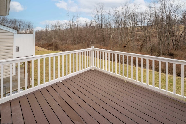 wooden terrace featuring a yard