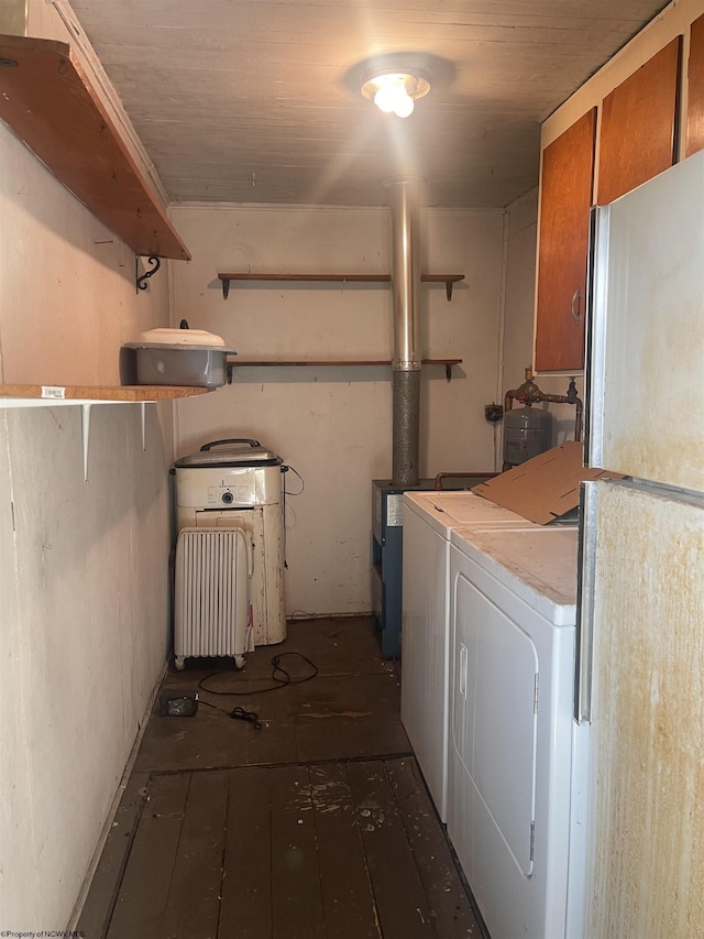 laundry room with laundry area, washer and clothes dryer, and hardwood / wood-style flooring