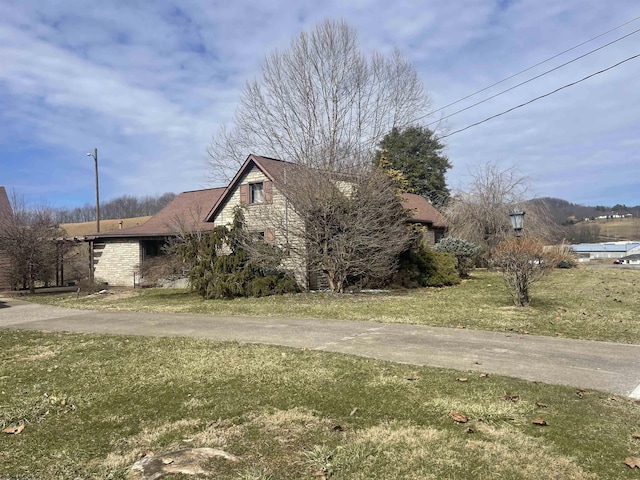 view of side of home featuring a yard