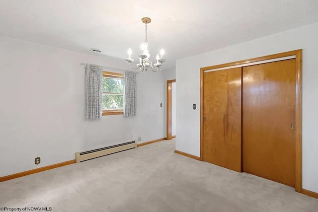 unfurnished bedroom featuring a baseboard heating unit, light carpet, a chandelier, and baseboards