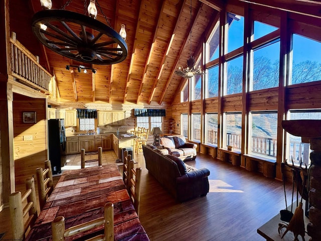 living area with light wood-style flooring, wooden walls, high vaulted ceiling, wooden ceiling, and beamed ceiling