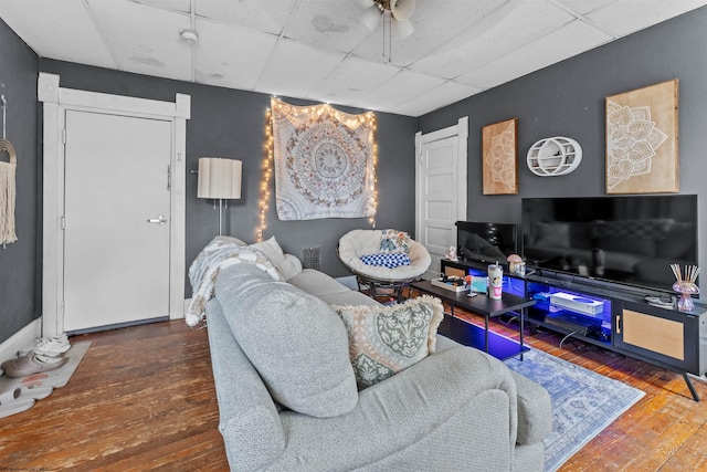 living room featuring a paneled ceiling and hardwood / wood-style floors