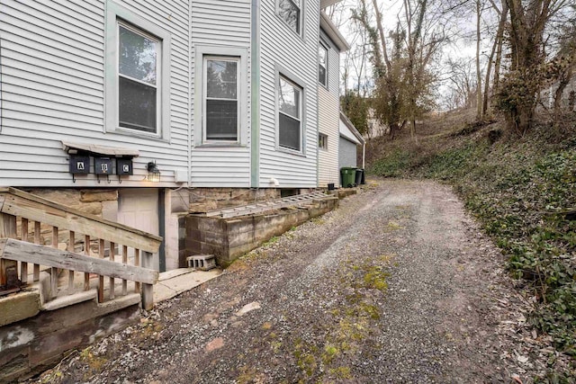 view of property exterior featuring dirt driveway