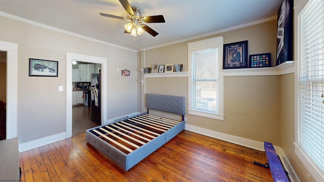 bedroom with baseboards, ceiling fan, hardwood / wood-style floors, and crown molding