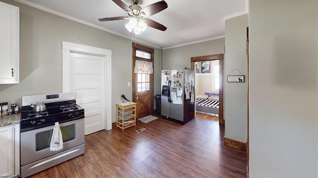 kitchen with white cabinets, a ceiling fan, appliances with stainless steel finishes, dark wood-type flooring, and crown molding