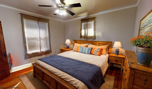 bedroom with multiple windows, wood finished floors, and crown molding