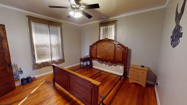 bedroom with baseboards, ornamental molding, ceiling fan, and hardwood / wood-style floors