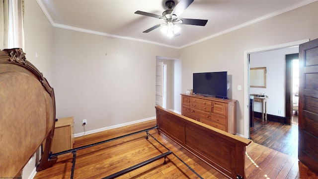 bedroom featuring ornamental molding, hardwood / wood-style flooring, and baseboards