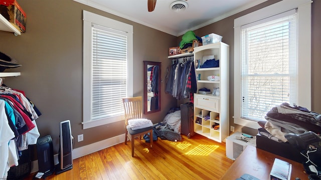 spacious closet featuring a ceiling fan, visible vents, and hardwood / wood-style floors