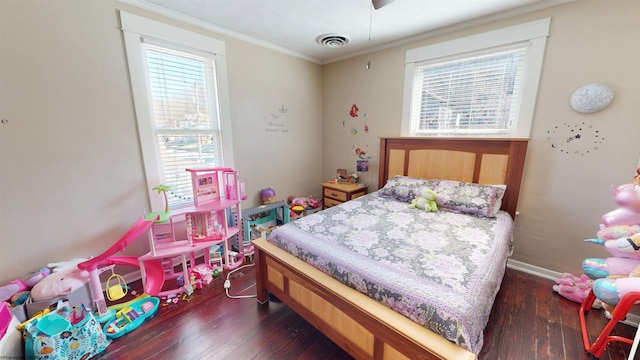 bedroom with crown molding, multiple windows, visible vents, and dark wood-style flooring