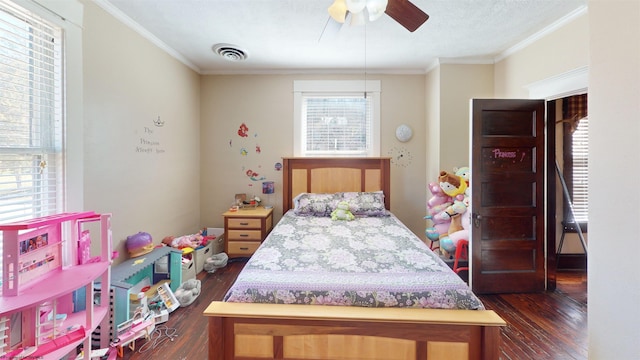 bedroom featuring dark wood-style floors, a ceiling fan, visible vents, and crown molding