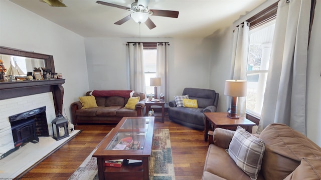 living area with a ceiling fan and hardwood / wood-style floors