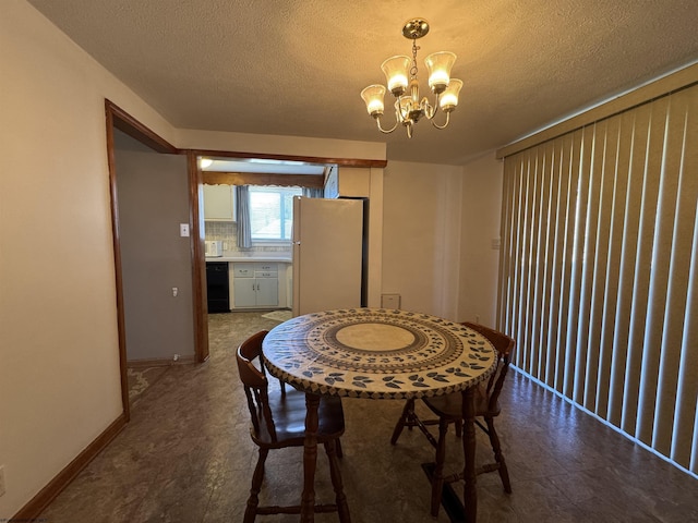 dining area with a notable chandelier, a textured ceiling, and baseboards