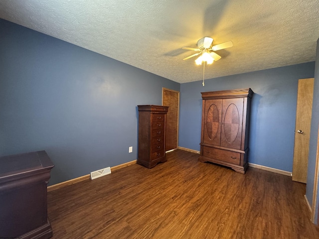 unfurnished bedroom with visible vents, a ceiling fan, a textured ceiling, wood finished floors, and baseboards