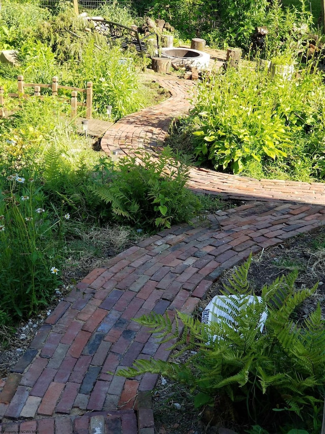 surrounding community featuring an outdoor fire pit