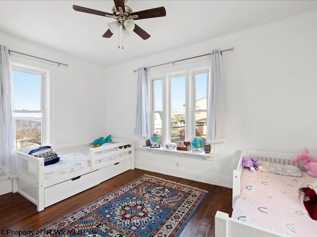 bedroom with hardwood / wood-style flooring, baseboards, and a ceiling fan