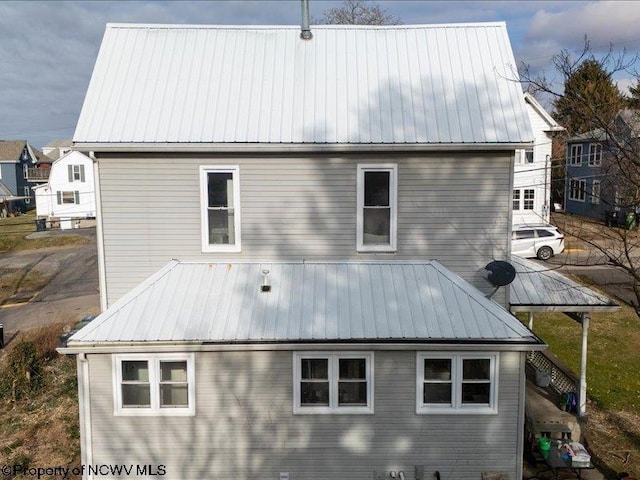 rear view of property with metal roof