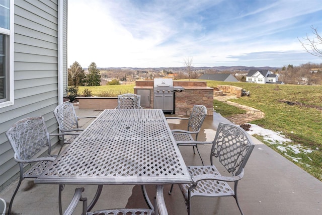 view of patio / terrace with outdoor dining space and a grill