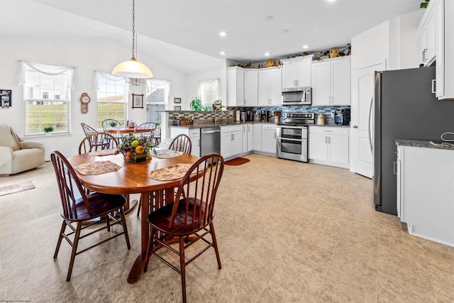 dining space featuring vaulted ceiling and recessed lighting