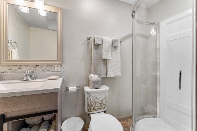 full bathroom featuring vanity, a shower stall, and toilet