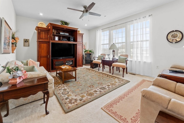 living area with light carpet, a ceiling fan, and recessed lighting