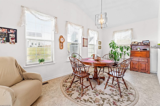 dining room featuring vaulted ceiling, visible vents, and baseboards