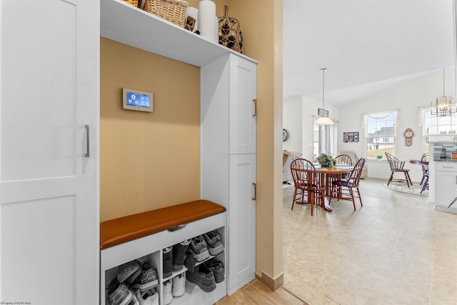 mudroom featuring vaulted ceiling and baseboards