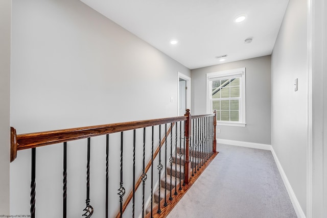 corridor with recessed lighting, carpet flooring, an upstairs landing, and baseboards